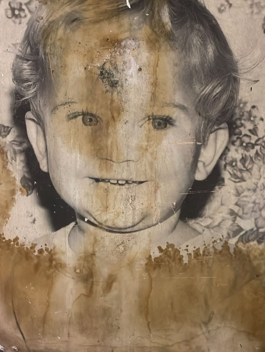 Water-damaged photo of child